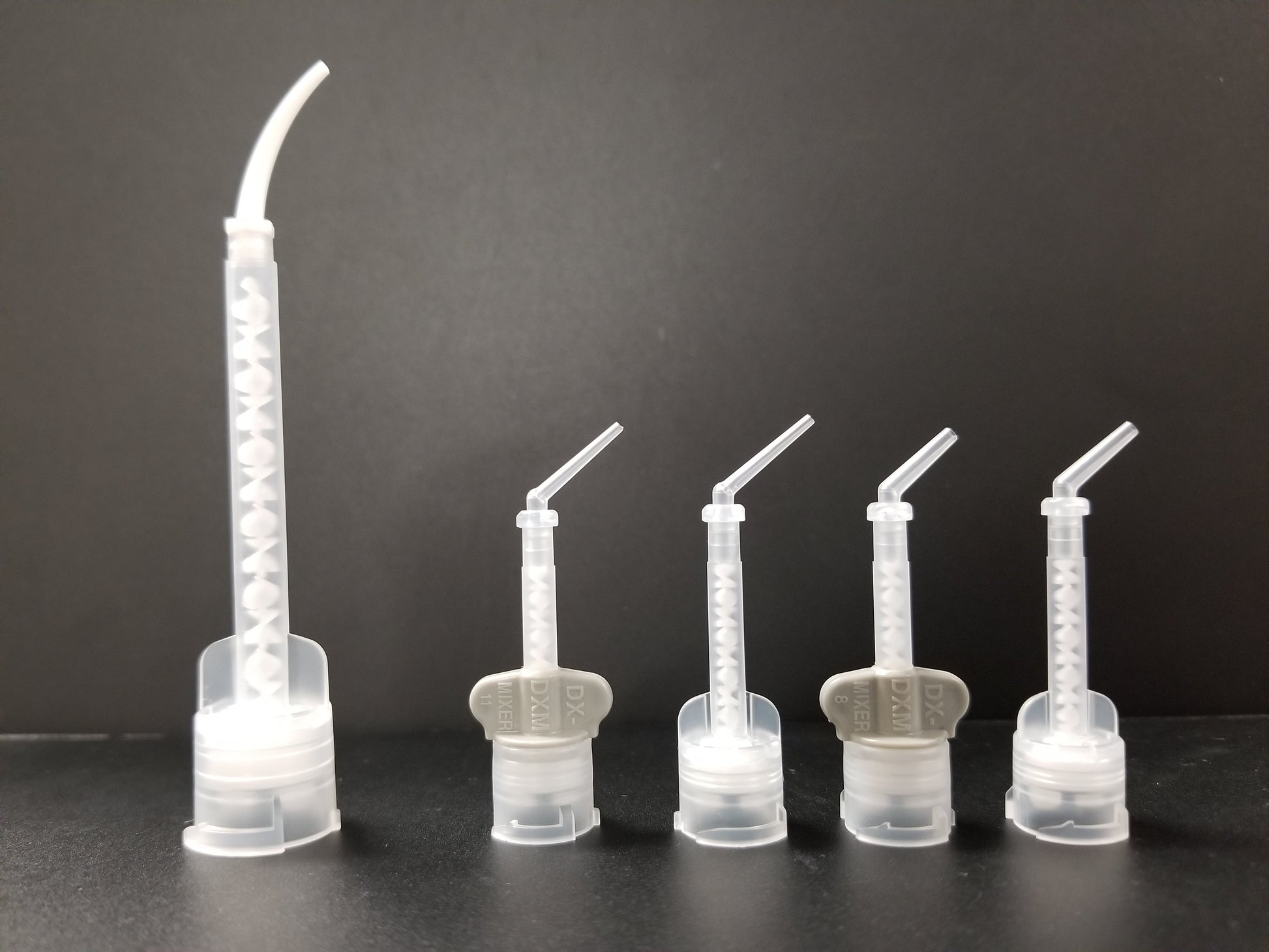 Intra oral tips attached to their respective mixing tips. 
